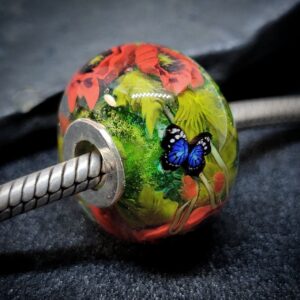 Red poppy bead with a blue butterfly